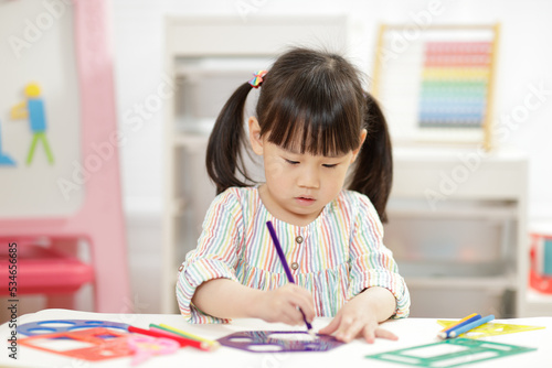 young girl practice drawing different shapes for homeschooling