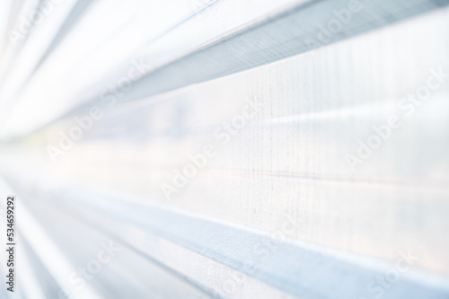 Stainless steel fence. Silver colored metal plate with lines used in construction. Image background.