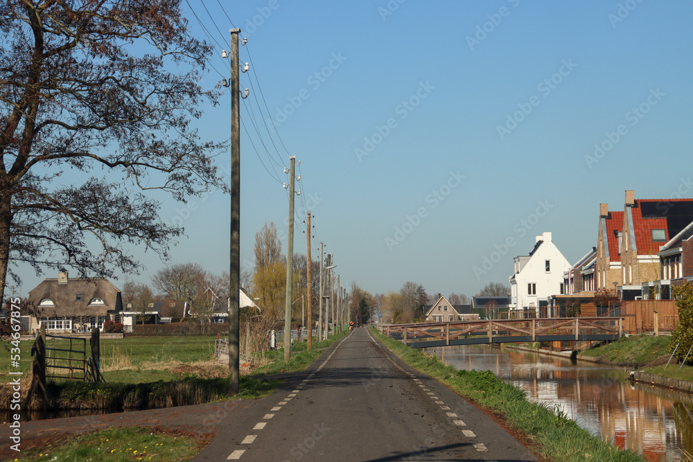 Wooden poles with electricity wires in the Zuidplaspolder at the Vierde Tochtweg