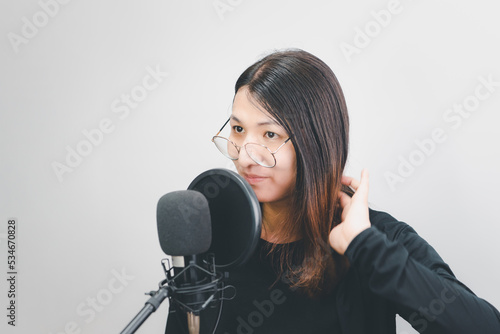 Woman (LGBTQ) singer sing a song with microphone photo