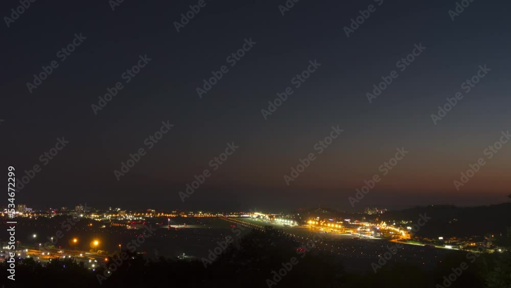 Airport timelapse with lights from moving airplanes landing taxiing and taking off at Sochi. Tourism and travel concept Airport timelapse with lights from moving airplanes landing taxiing and taking off at Sochi. Tourism and travel concept