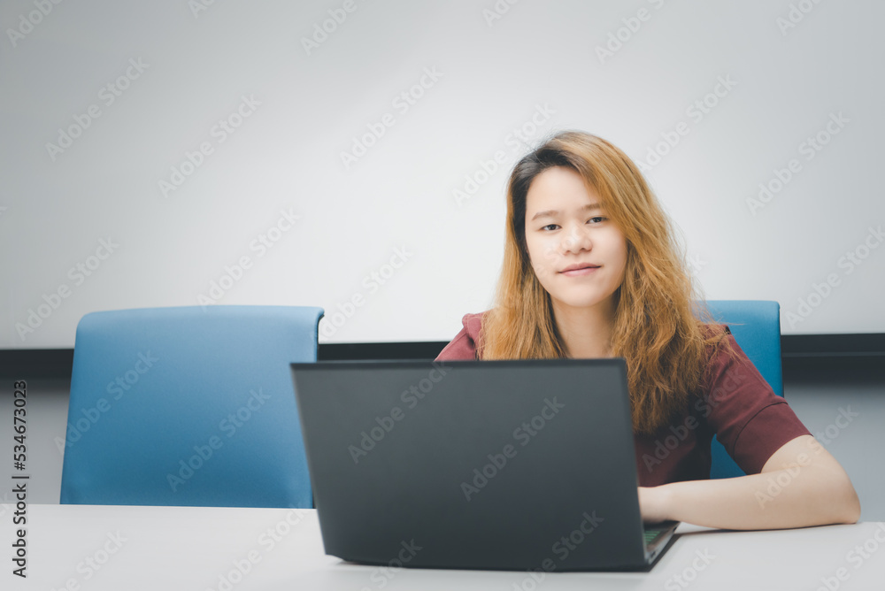 Woman working by laptop in office with happy Woman working by laptop in office with happy