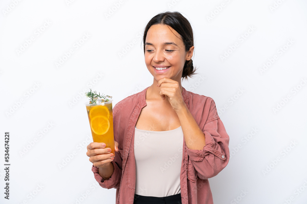 Young hispanic woman holding a cocktail isolated on white background looking to the side and smiling Young hispanic woman holding a cocktail isolated on white background looking to the side and smiling
