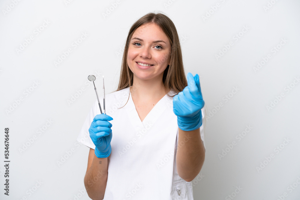 Dentist woman holding tools isolated on white background making money gesture Dentist woman holding tools isolated on white background making money gesture