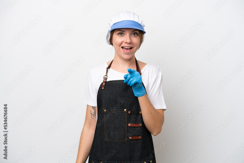 Fishmonger woman wearing an apron surprised and pointing front Fishmonger woman wearing an apron surprised and pointing front