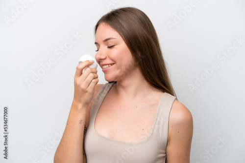 Young Lithuanian woman isolated on white background with moisturizer and smelling it
