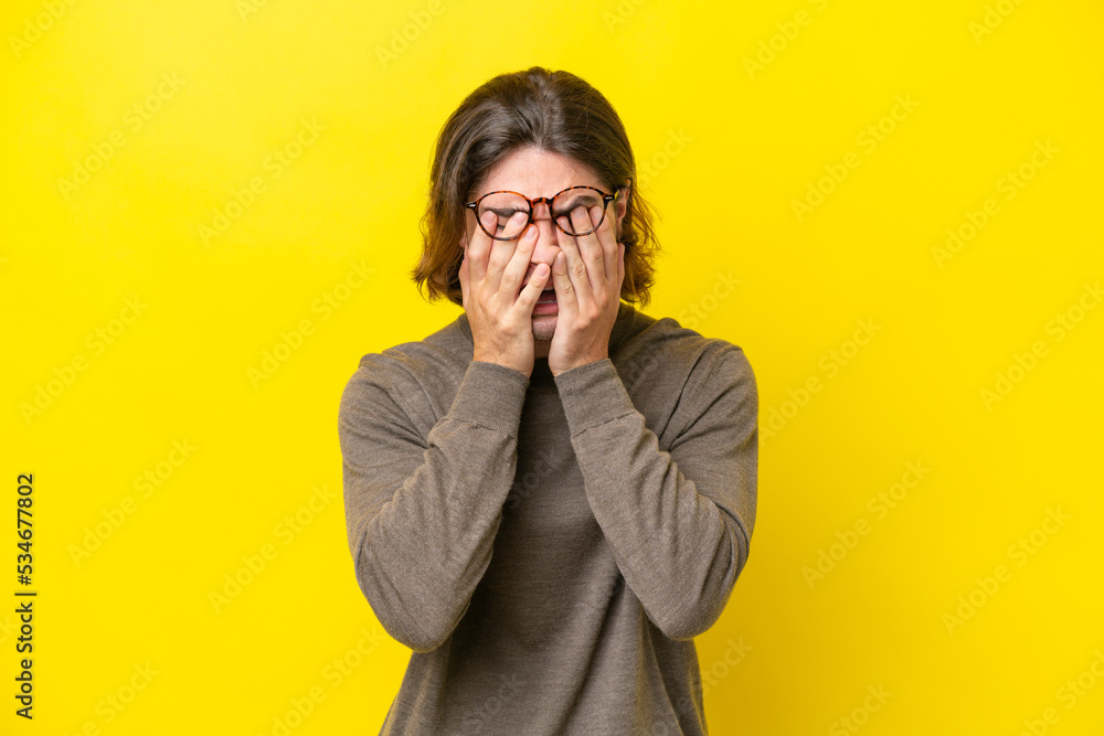 Caucasian handsome man isolated on yellow background with tired and sick expression Caucasian handsome man isolated on yellow background with tired and sick expression