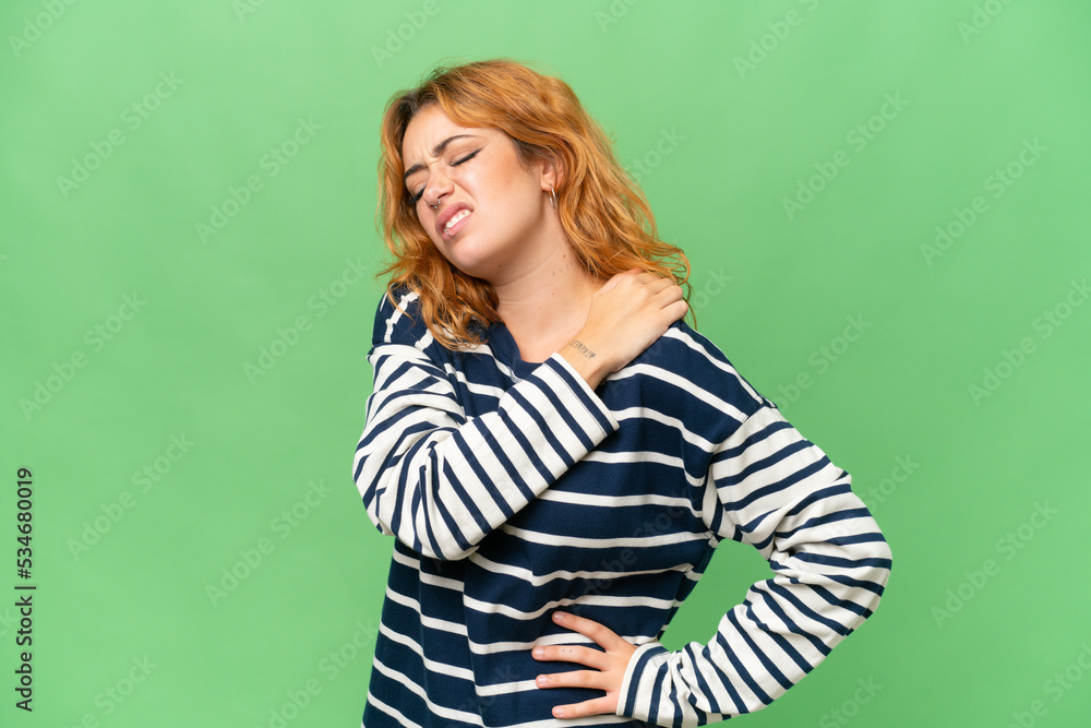 Young caucasian woman isolated on green screen chroma key background suffering from pain in shoulder for having made an effort Young caucasian woman isolated on green screen chroma key background suffering from pain in shoulder for having made an effort