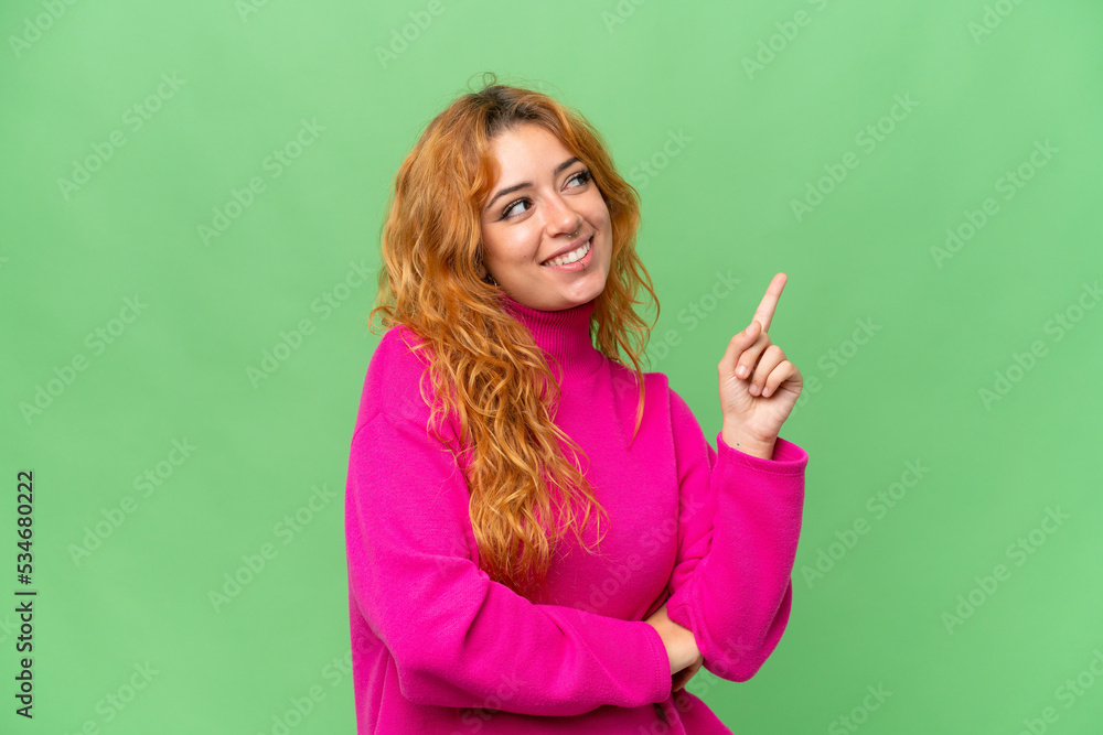 Young caucasian woman isolated on green screen chroma key background pointing up a great idea Young caucasian woman isolated on green screen chroma key background pointing up a great idea
