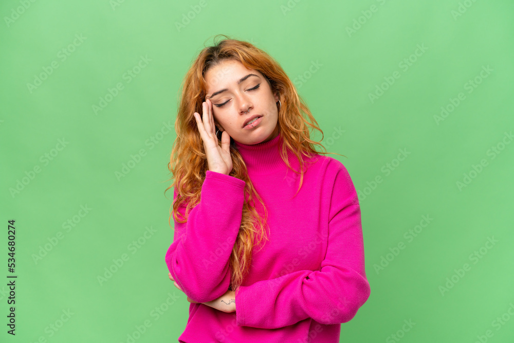 Young caucasian woman isolated on green screen chroma key background with headache Young caucasian woman isolated on green screen chroma key background with headache
