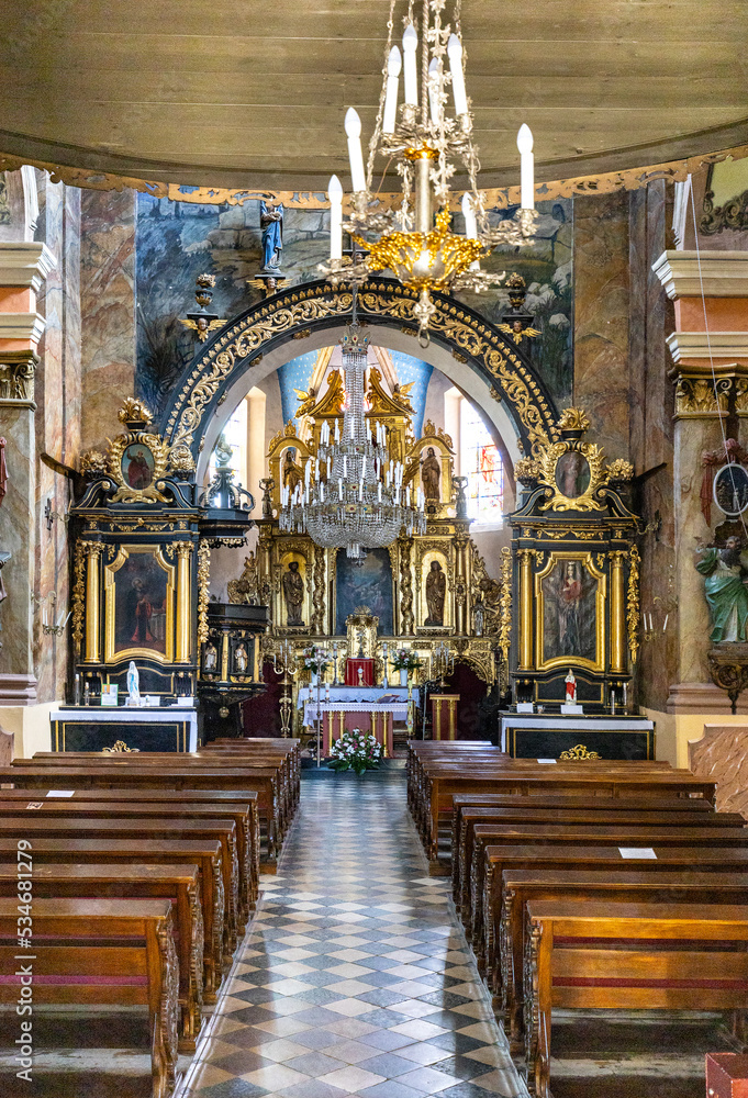 Obraz premium Pilica, Poland - July 25, 2022: Main nave of St. John Baptist parish church, kosciol Sw. Jana Chrzciciela, in historic old town quarter of Pilica in Silesia region of Poland