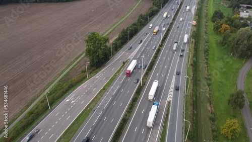 Drone aerial view of traffic at a highway ramp and cars merging into motorway lane in Antwerp, Belgium