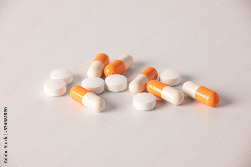 Tablets, medications on a white background, a scattering of tablets Tablets, medications on a white background, a scattering of tablets