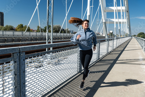 Young woman cancer survivor decides to change her way of life after illness and start practicing every morning as new life routine. Female workout training outdoor for health and happiness. © Srdjan