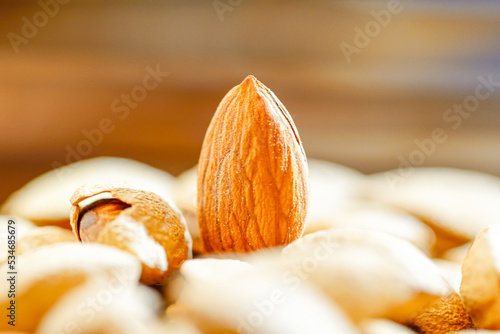 Close up a pile of almonds on the indoor table