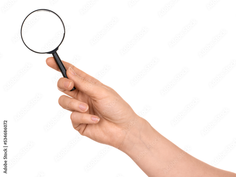 A woman's hand holds a small magnifying glass, the concept of information search. Isolated on white background. A woman's hand holds a small magnifying glass, the concept of information search. Isolated on white background.