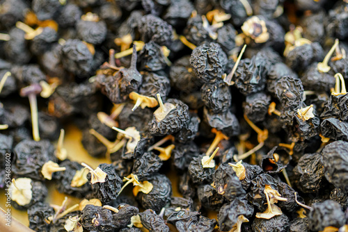 There are many naturally dried black wolfberries on the table