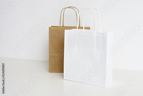 Paper Bags are standing in front of a white wall
