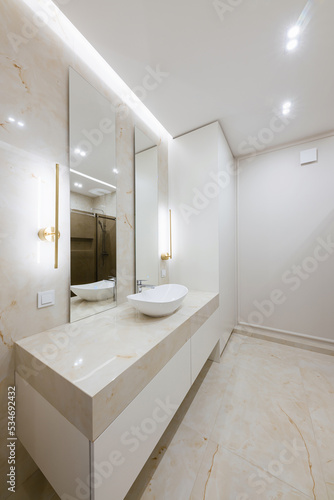 water sink with mirror and lighting in the bathroom