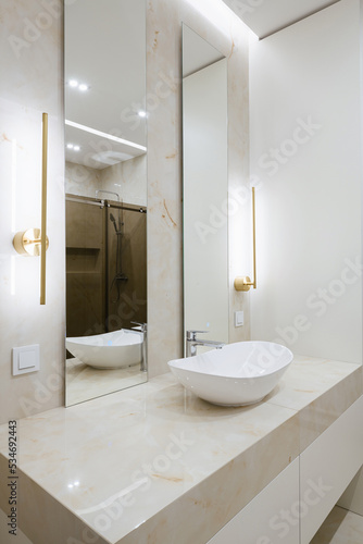 water sink with mirror and lighting in the bathroom