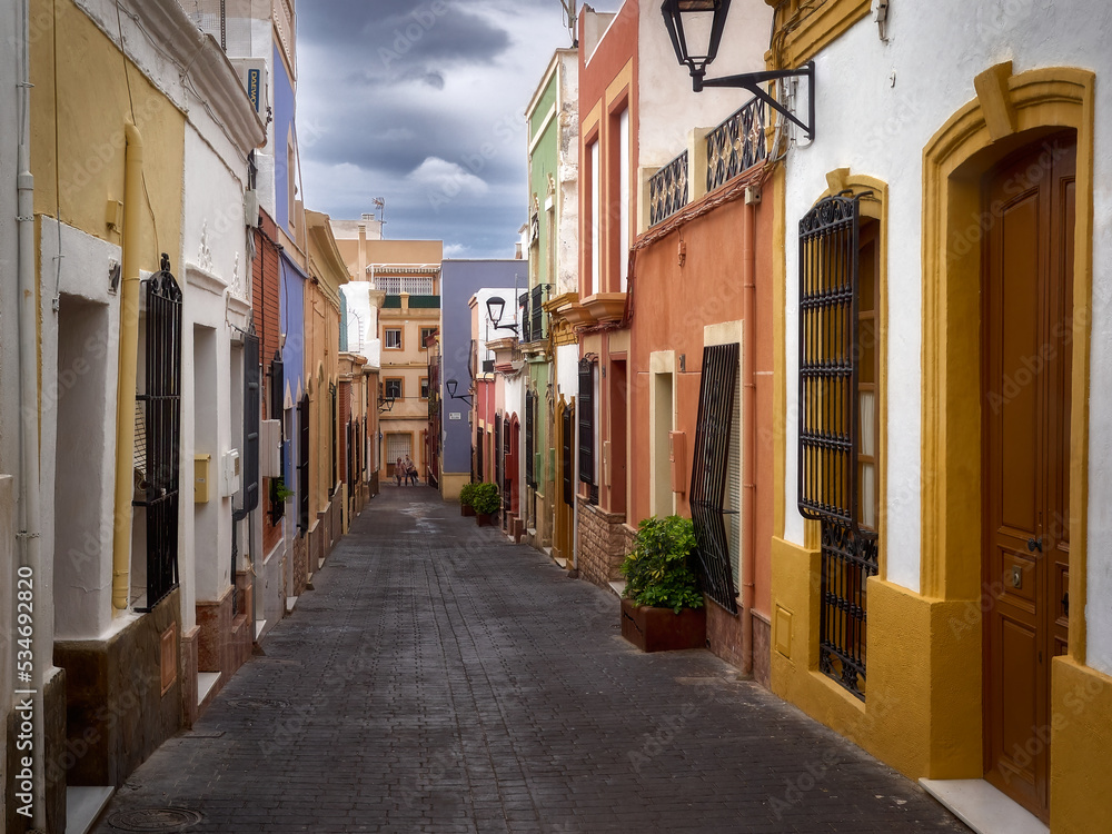 Obraz premium Typical street of colorfully painted houses and barred windows