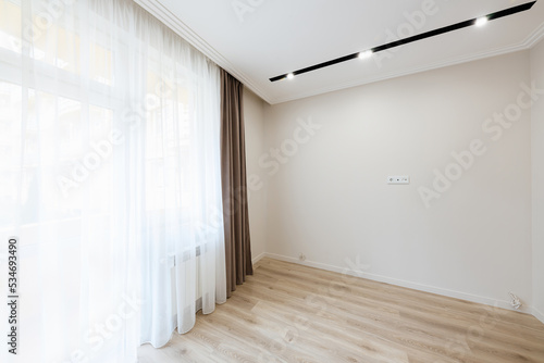 interior design of an empty room with a large window in a new bright house