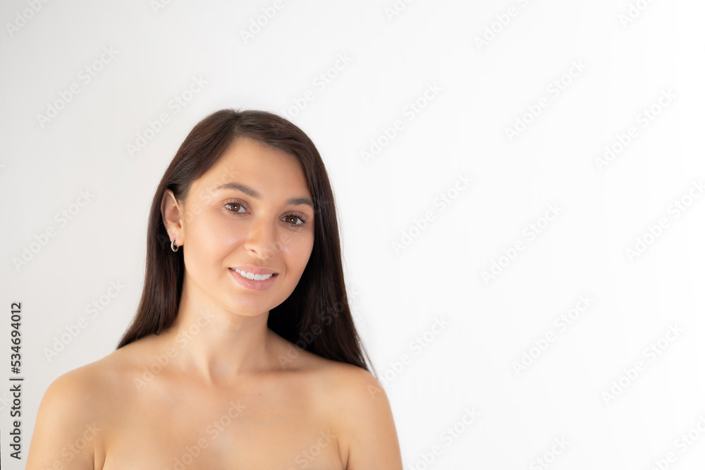 Beautiful young woman brunette with natural beauty and natural makeup on a white background. Space for text. Beautiful young woman brunette with natural beauty and natural makeup on a white background. Space for text.