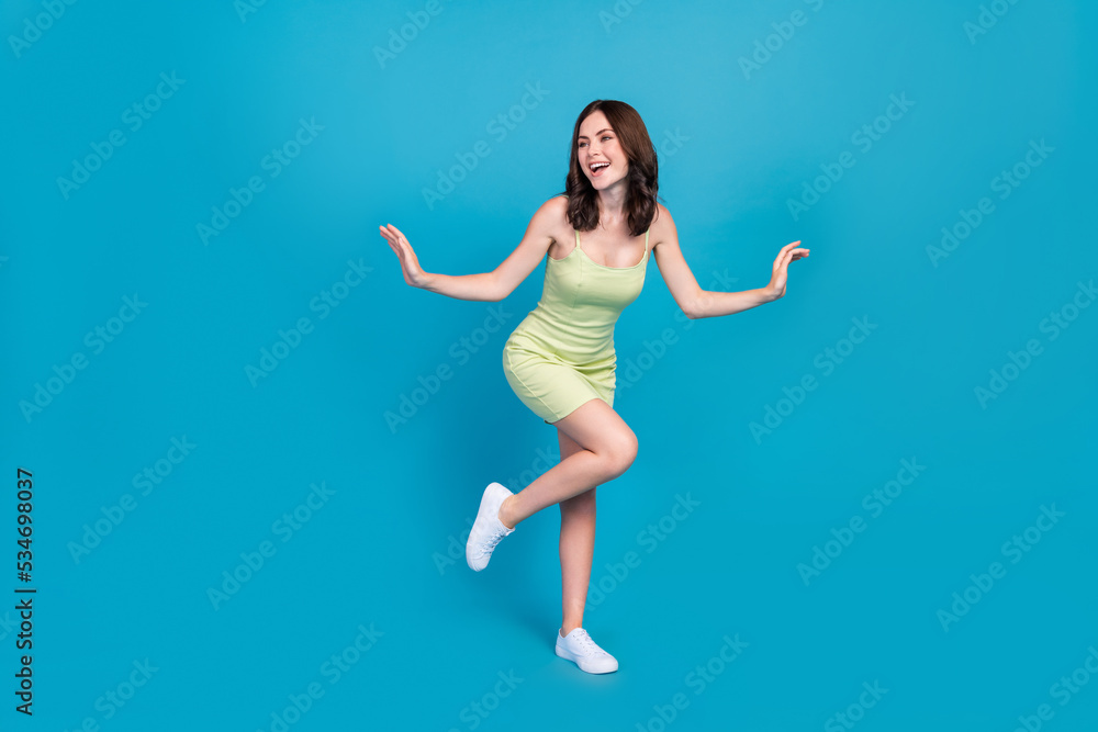 Full length photo of adorable glad lady dancing chilling good mood isolated on blue color background Full length photo of adorable glad lady dancing chilling good mood isolated on blue color background