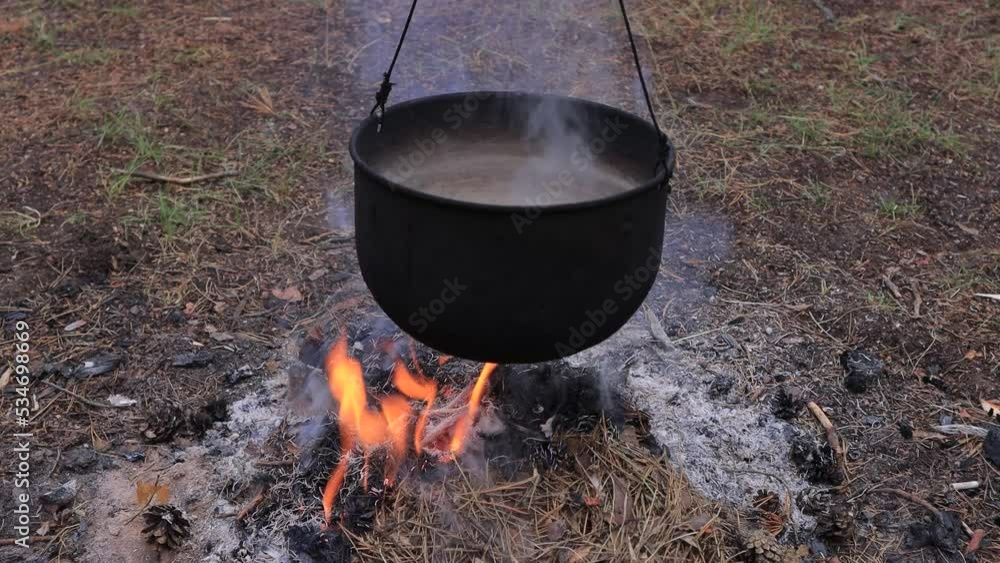 Smoke from a campfire and a pot of food Smoke from a campfire and a pot of food