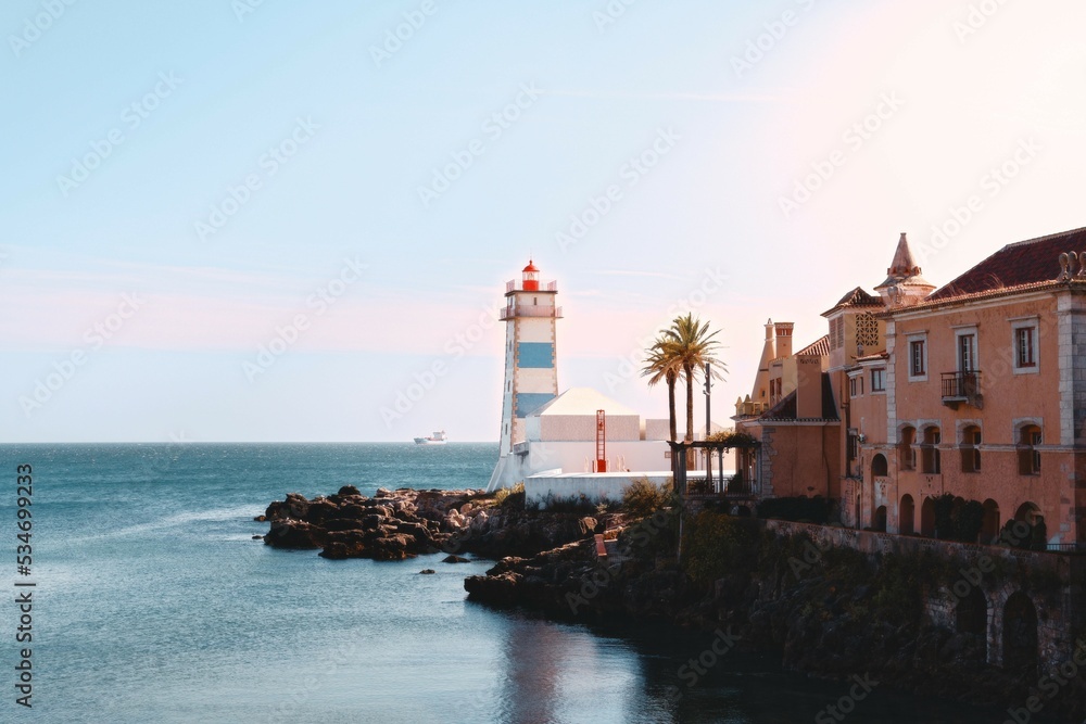 Old lighthouse in cascais at sunset, Lisbon