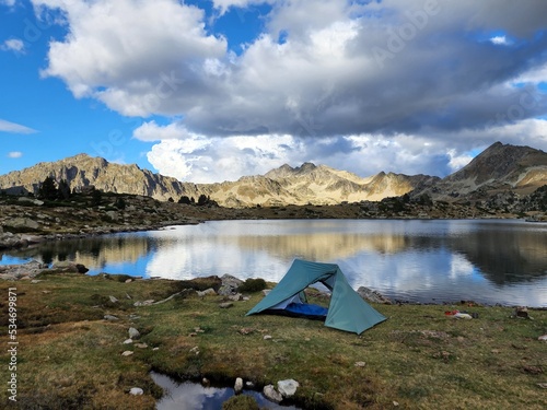 Camping tent in the mountains by a lake