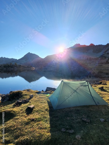 Camping tent in the mountains by a lake