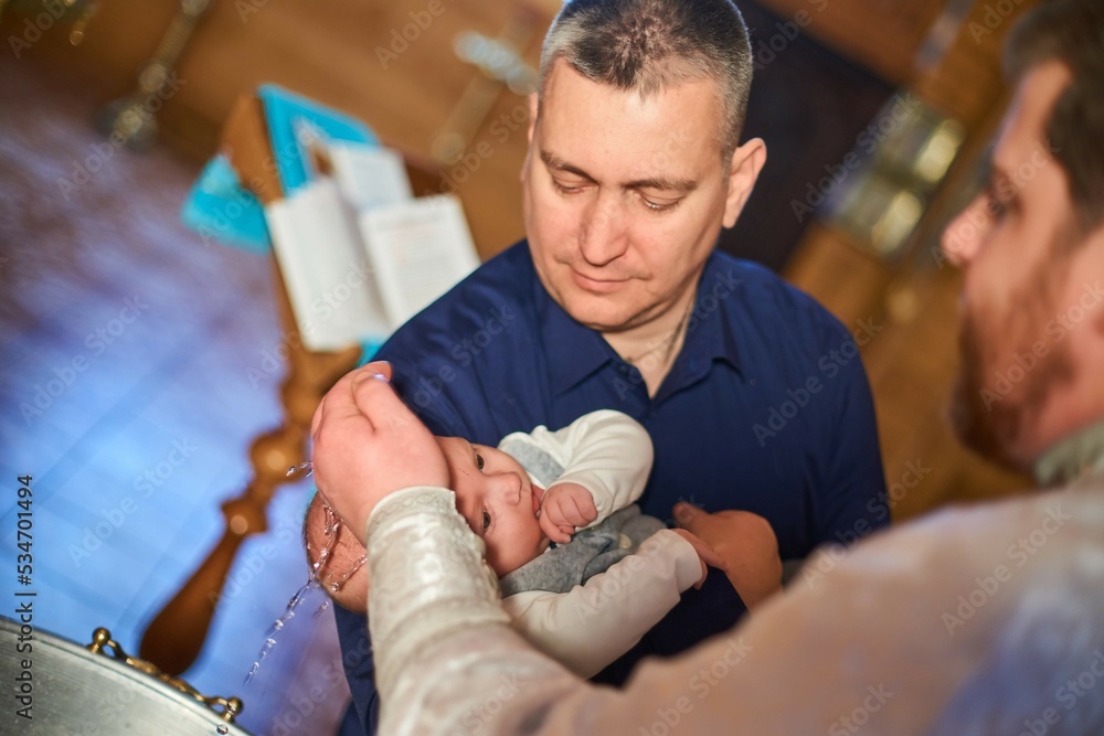 Baptism of a newborn in holy water. Bathing youth on the water. Baptism