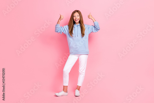 Full size portrait of positive girl two arms fingers demonstrate thumb up approve isolated on pink color background