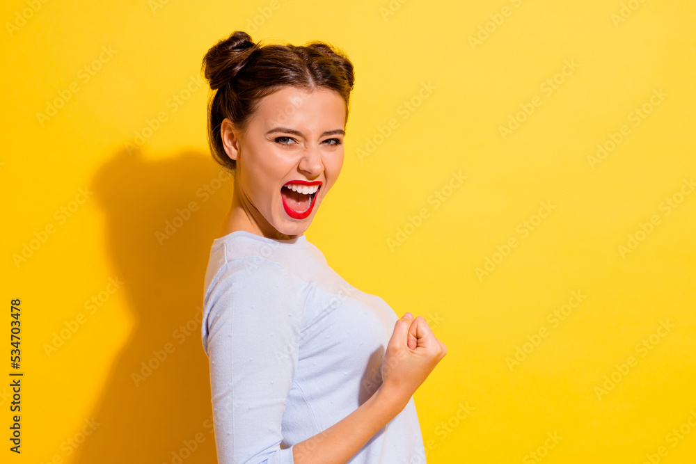 Profile side photo of delighted lady achieve luck goal fist up gesture scream yeah loud isolated shine color background Profile side photo of delighted lady achieve luck goal fist up gesture scream yeah loud isolated shine color background