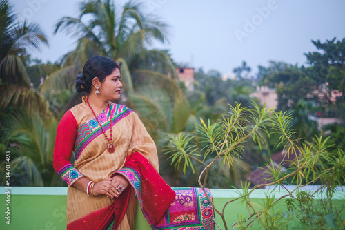 Portrait of south asian hindu religious young newly married woman wearing traditional costumes  © Susmit