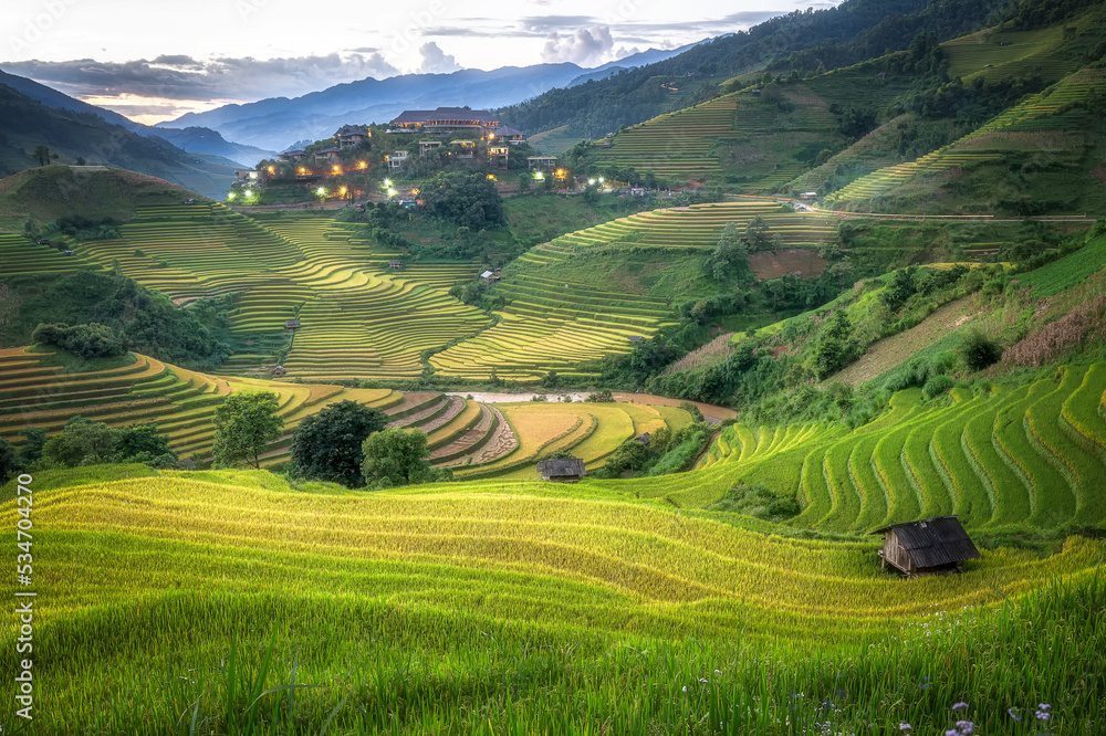 Beautiful scenery of rice terrace fields at Mu Cang Chai in northern Vietnam. Rice terrace fields is changing from green to be yellow for ready for rice harvest around beginning of October month.