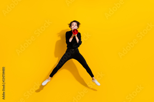 Photo of pretty cute girl dressed formal shirt jumping high screaming discount message empty space isolated yellow color background