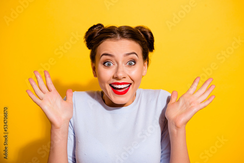 Photo of impressed crazy female win money in lottery giveaway become rich isolated on yellow color background