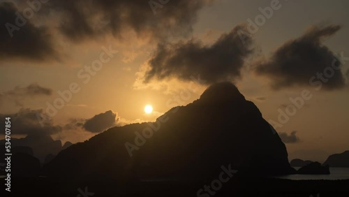 4K beautiful glowing sunset going up behind a SMED NANG-SHE mountain top photo