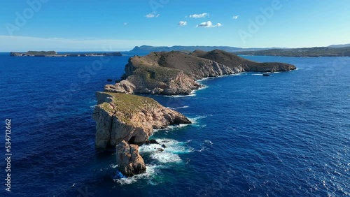 Waves Crashing Against Rocks on the Steep Shores of an Island photo