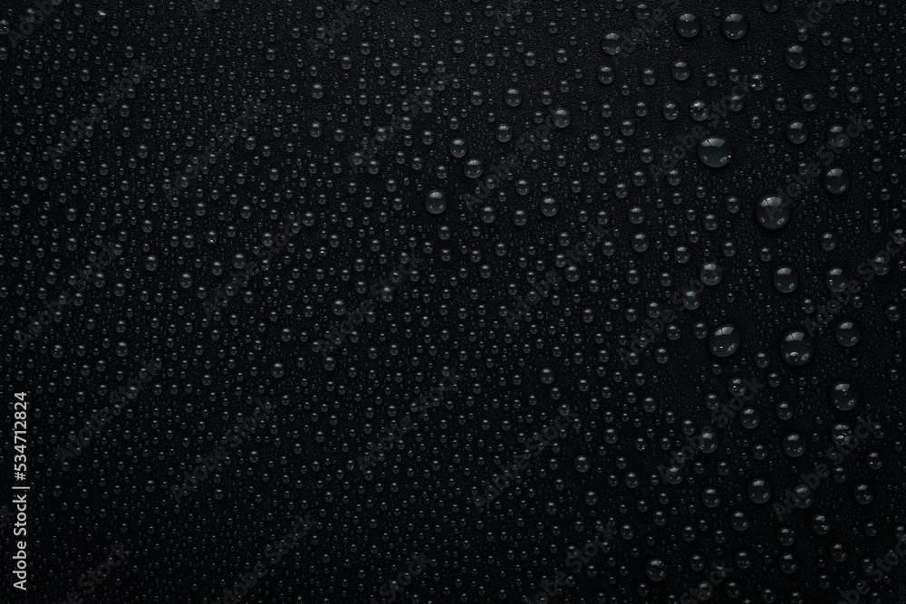 Water drops on a black background. Banner with raindrops. Top view. Water drops on a black background. Banner with raindrops. Top view.
