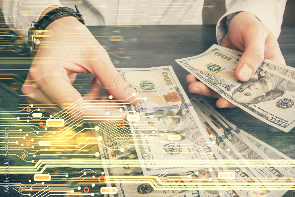 Double exposure of technology drawing hologram and us dollars bills and man hands. Data concept Double exposure of technology drawing hologram and us dollars bills and man hands. Data concept