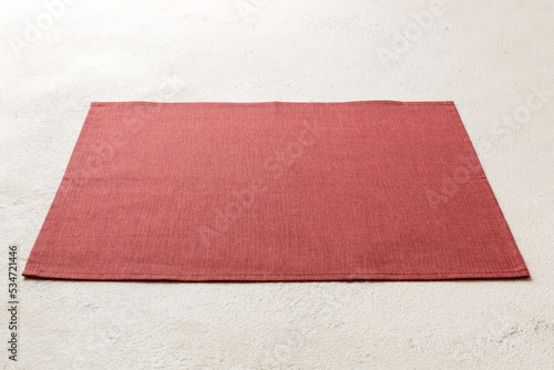 Perspective view of red tablecloth for food on cement background. Empty space for your design photo