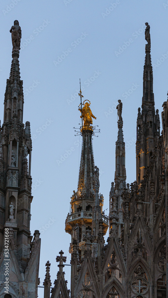 The milan cathedral, one of the most famous attractions in italy, with the lights of dawn, at the beginning of a summer day - July 2022.