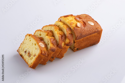 Sliced butter cake on white background