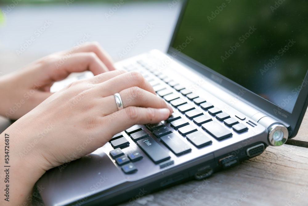 Business asian woman working with laptop in garden of cafe Business asian woman working with laptop in garden of cafe