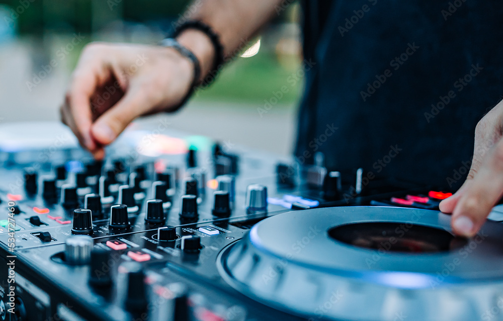 DJ Hands creating and regulating music on dj console mixer in concert outdoor DJ Hands creating and regulating music on dj console mixer in concert outdoor