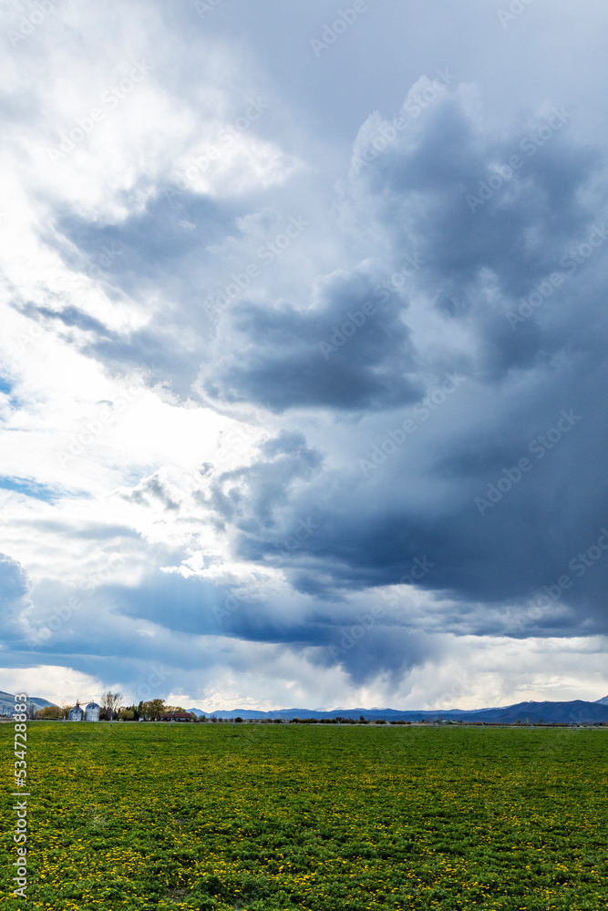 Usa, Idaho, Bellevue, Clouds above green field Usa, Idaho, Bellevue, Clouds above green field