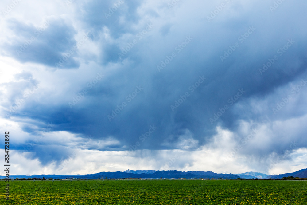 Usa, Idaho, Bellevue, Storm clouds above green field Usa, Idaho, Bellevue, Storm clouds above green field